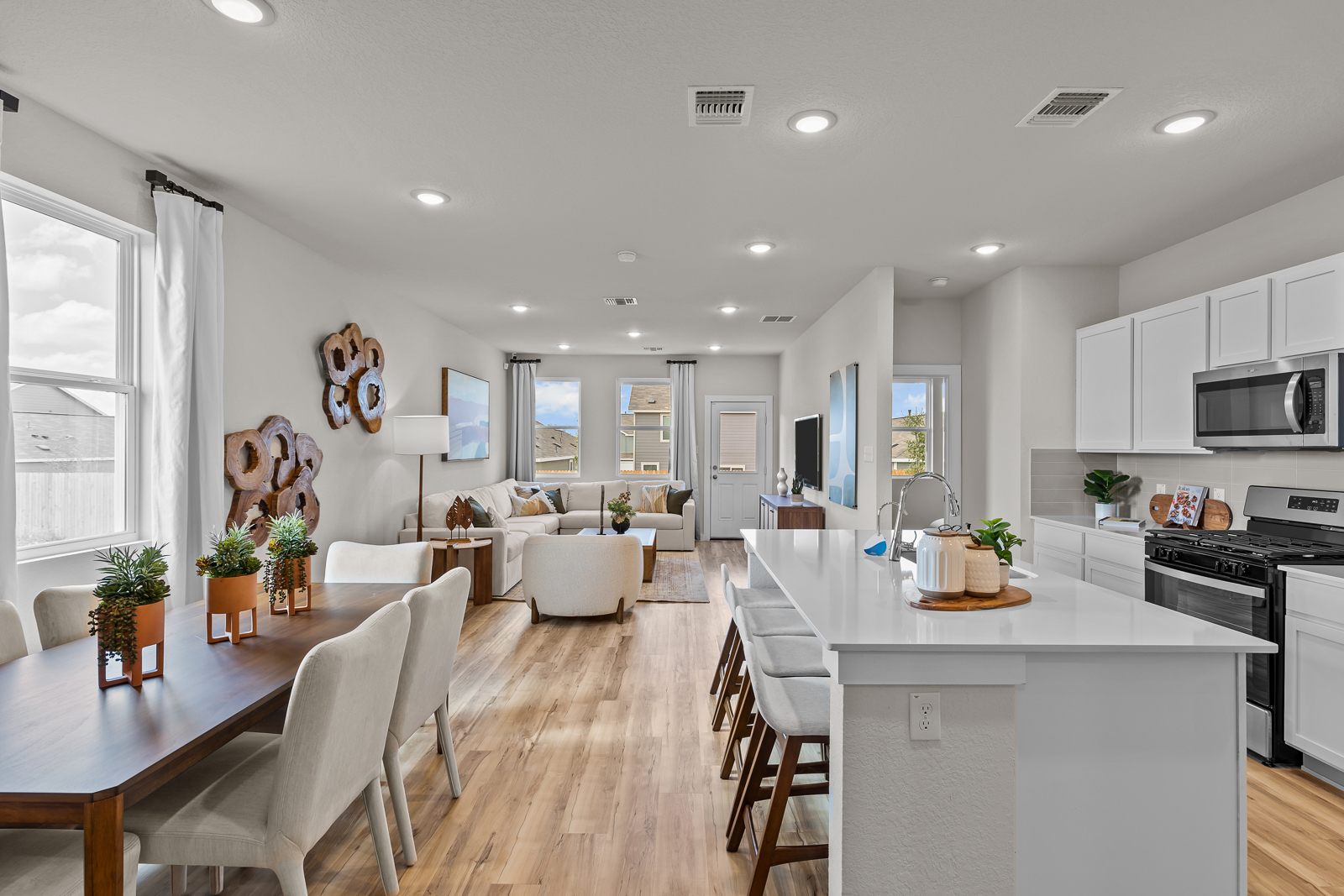 A kitchen with white cabinets.