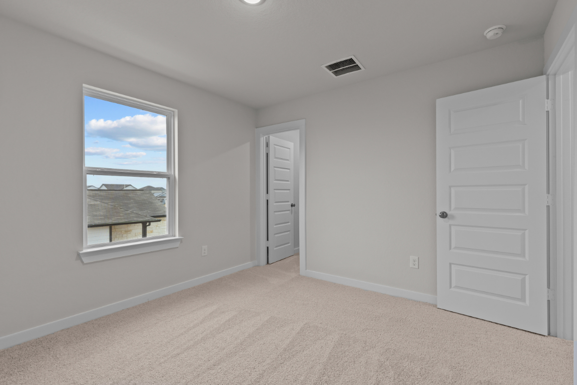 A room with a window and a door.