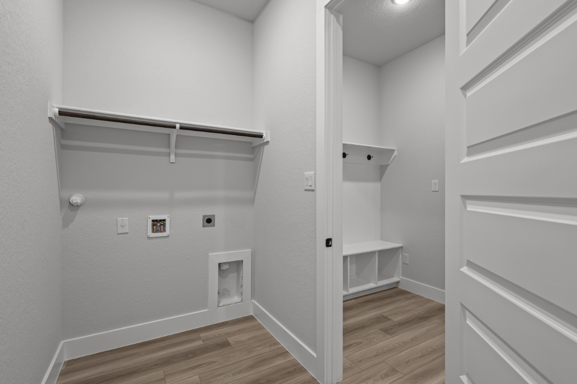 A white room with a wood floor.