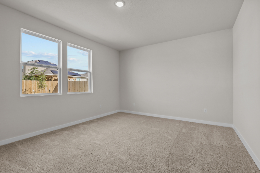 A room with a window and a carpet.