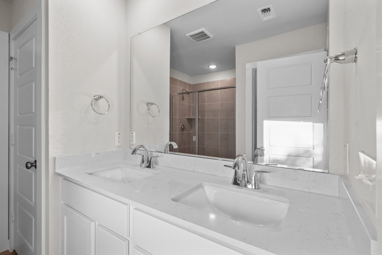 A bathroom with a large mirror.