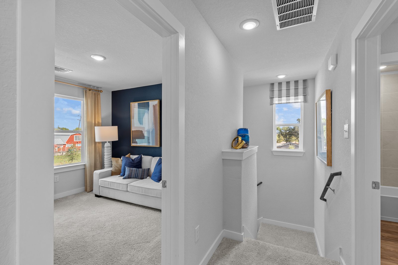 A living room with a couch and a lamp.