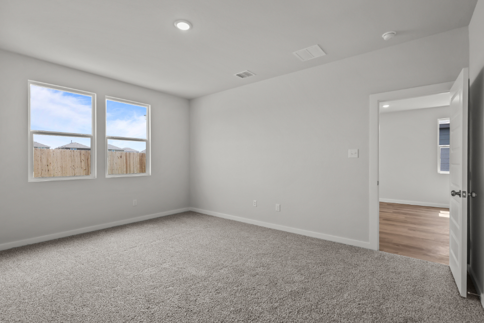 A room with a carpet and a door.