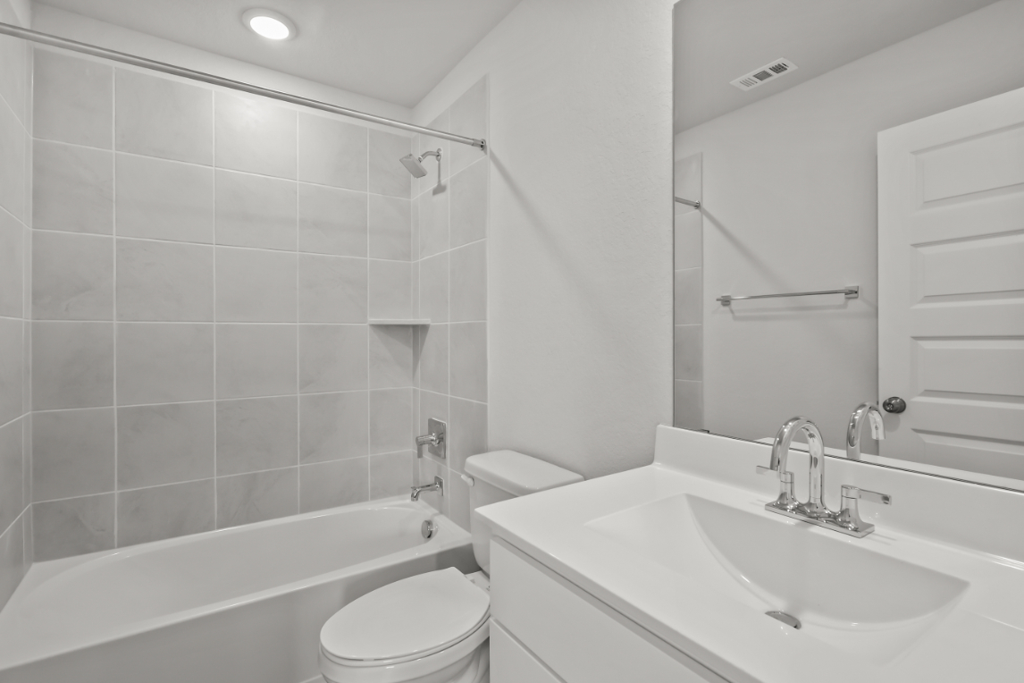 A bathroom with a sink toilet and bathtub.