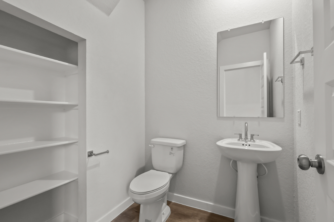 A bathroom with a toilet and sink.