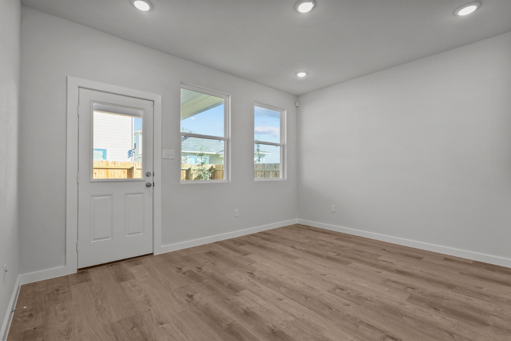 A room with a wood floor and white walls.