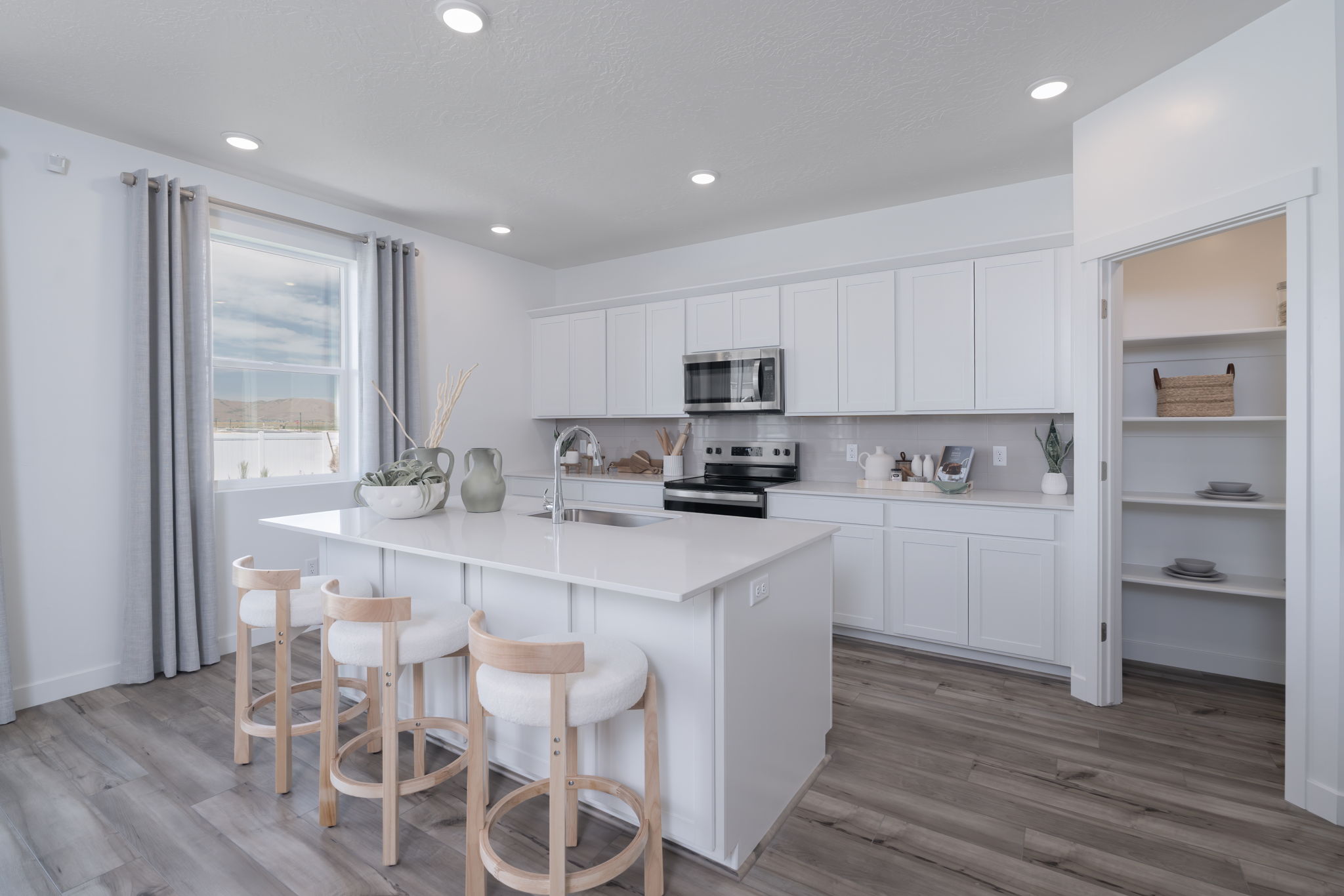 A kitchen with white cabinets.
