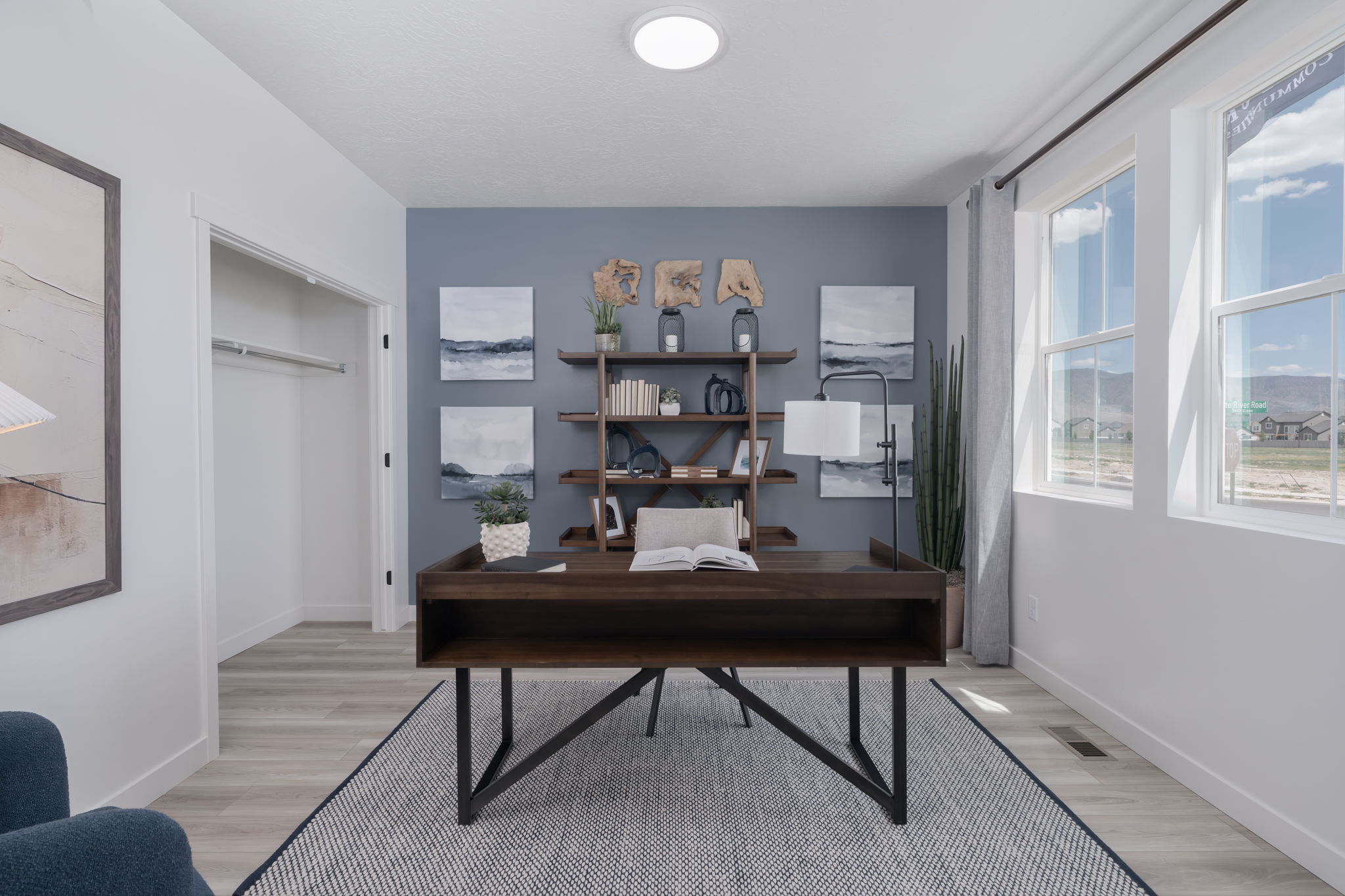 A room with a desk and shelves.