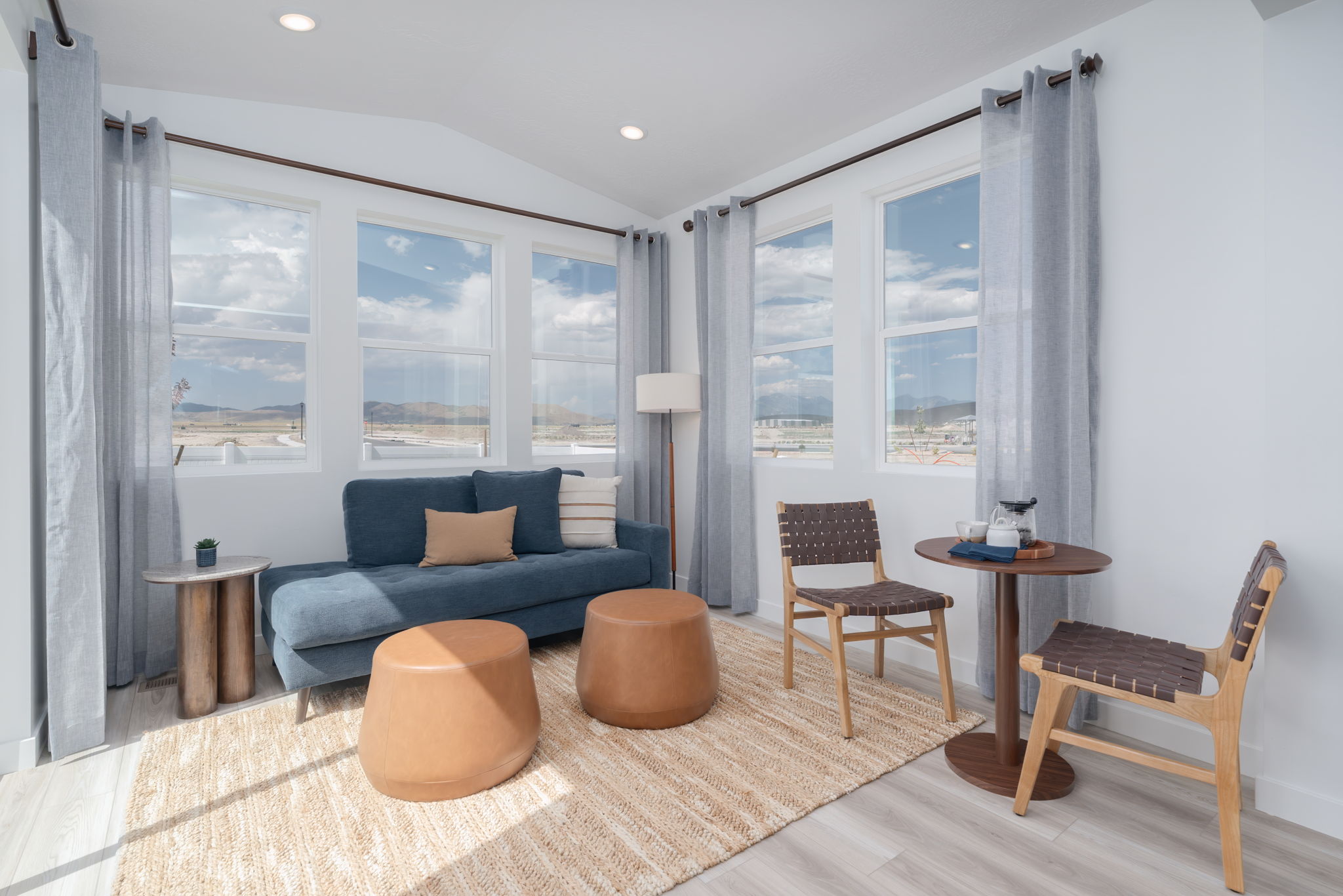 A living room with a blue couch and a table.