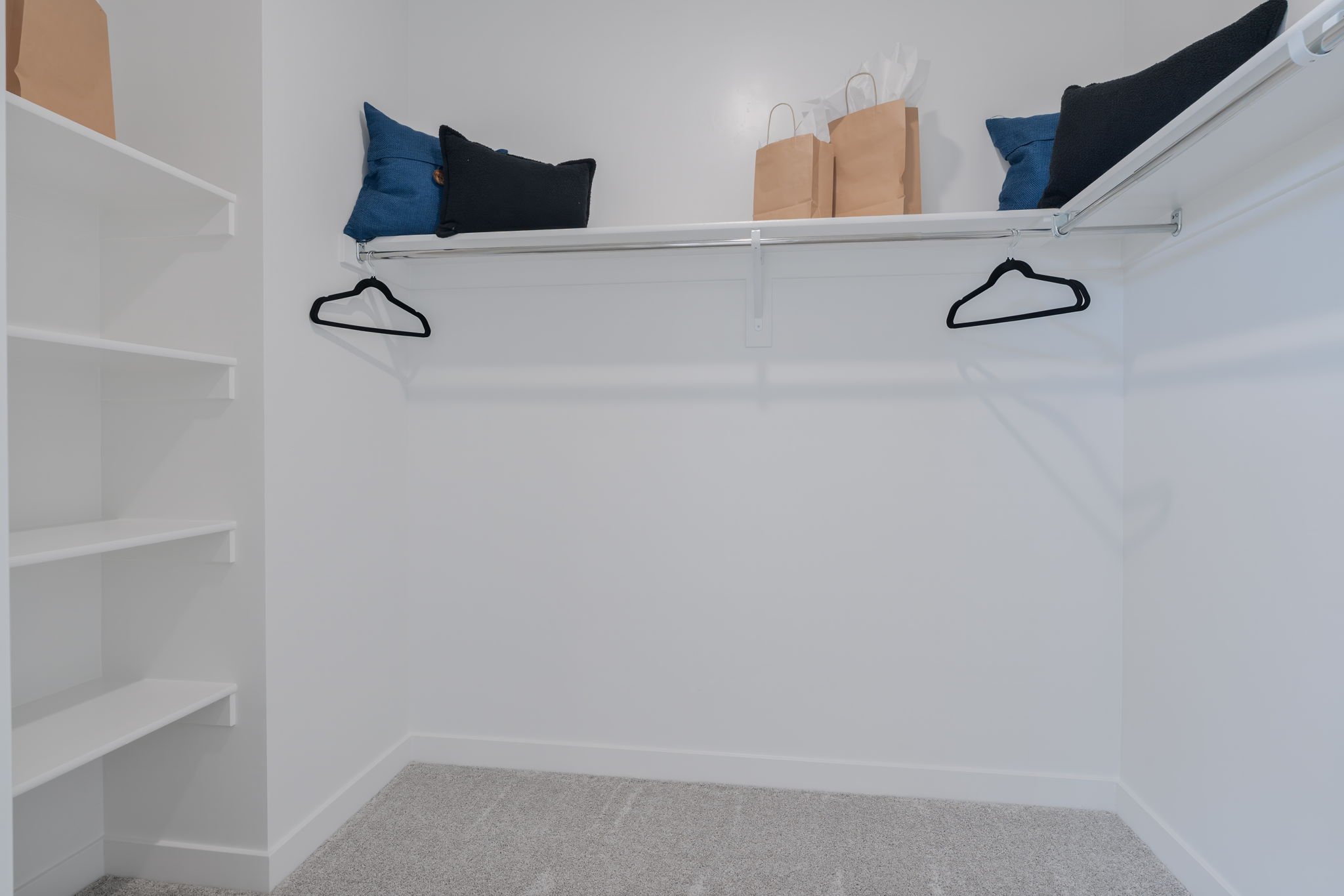 A white shelving unit with glasses.