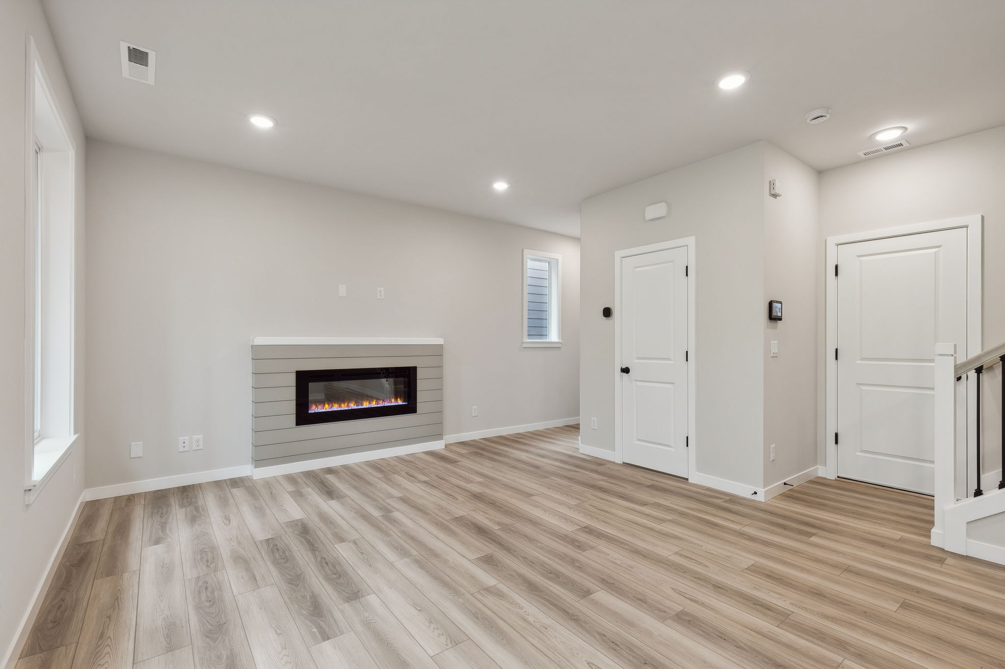 A room with a fireplace and wood floors.