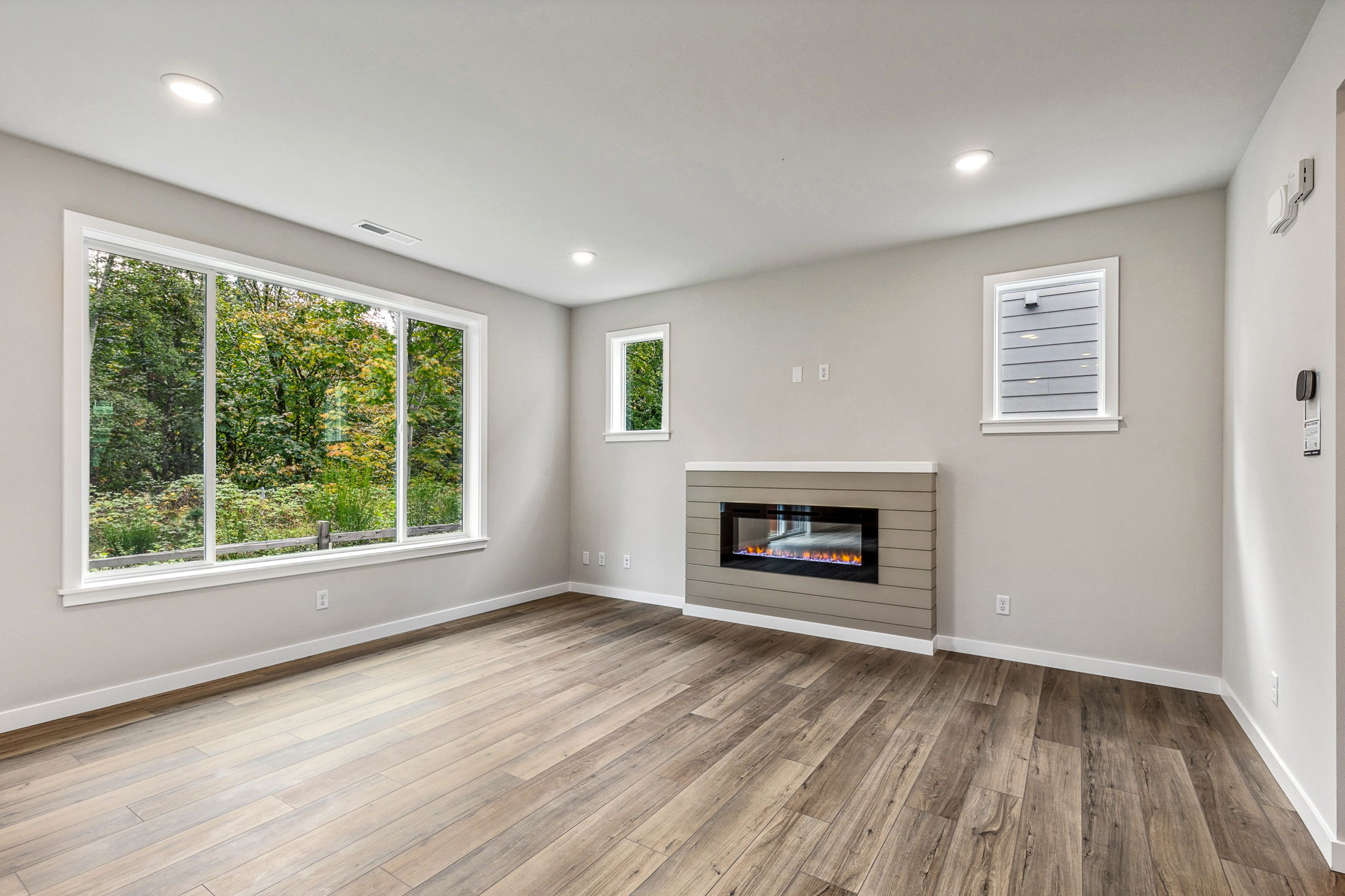 A room with a fireplace and a wood floor.
