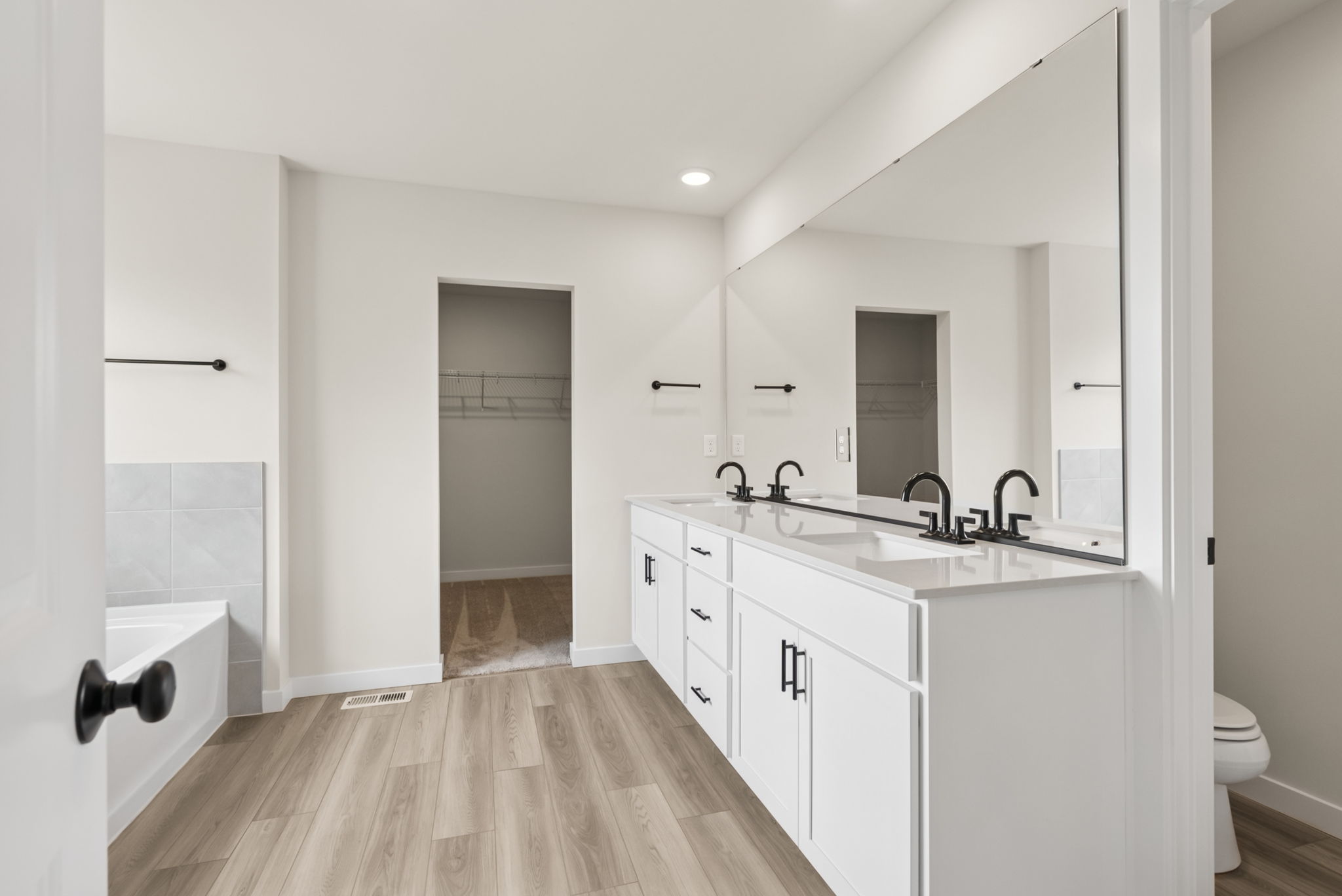 A bathroom with a wood floor.