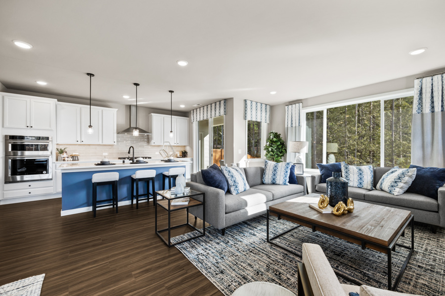 A large living room with a large kitchen and a large island.