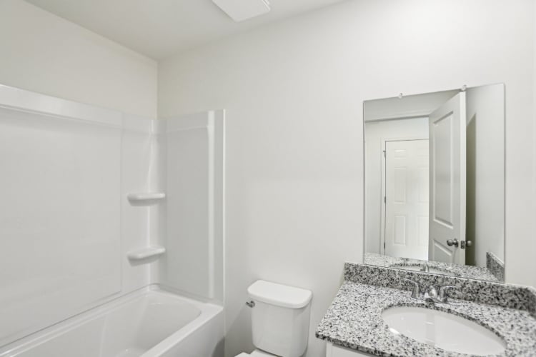 A bathroom with a marble countertop.