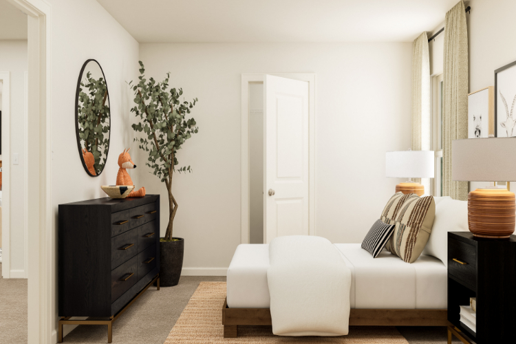 A living room with a white couch and a white door.