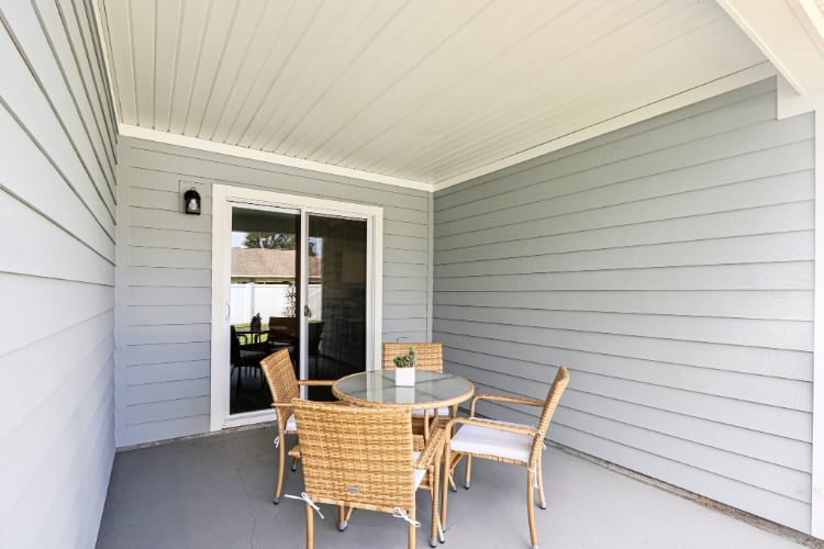 A dining room with a table and chairs.