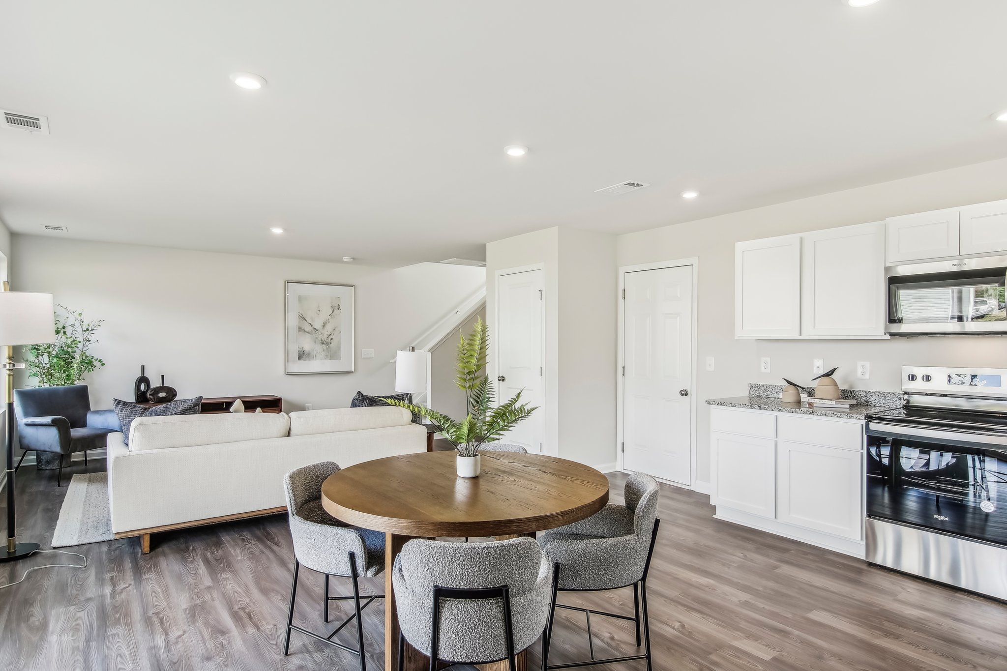 A kitchen with a table and chairs.