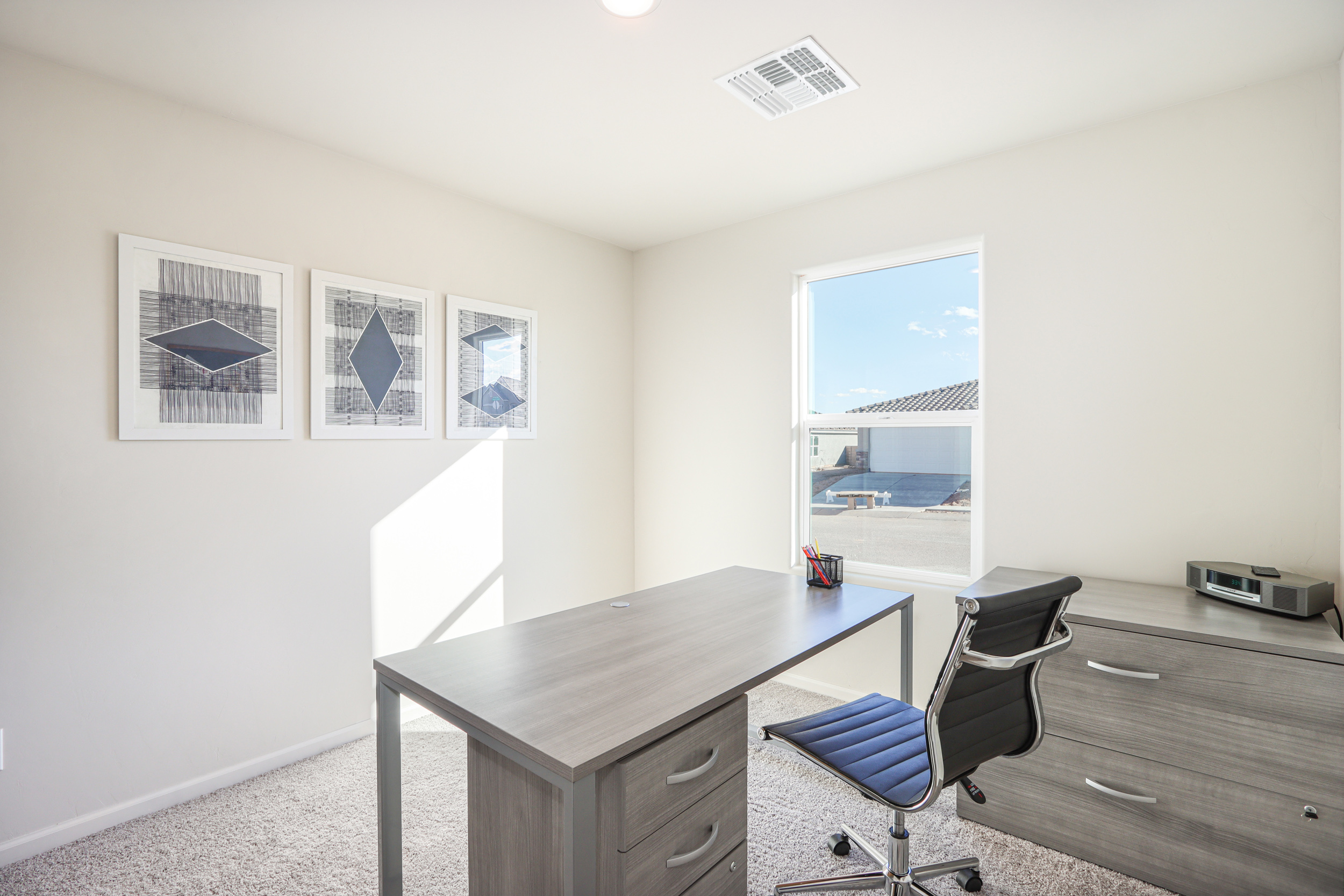 An office with a desk and chairs.