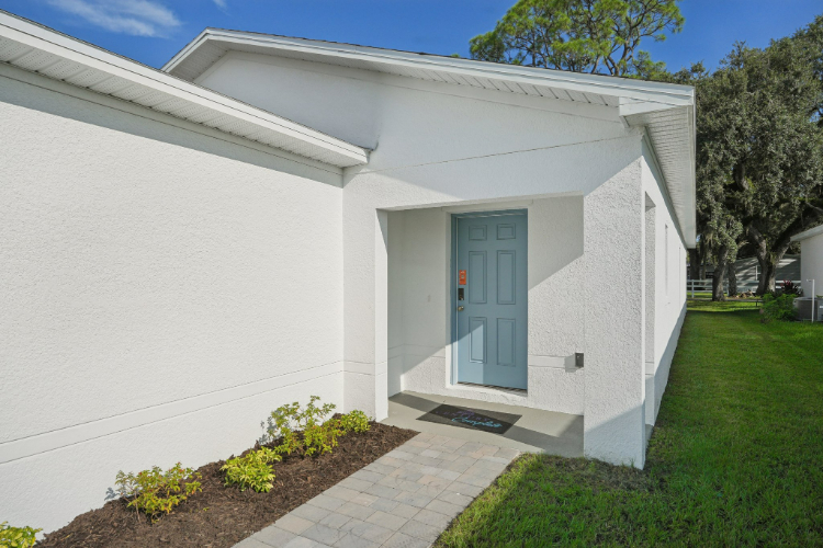 A white house with a blue door.