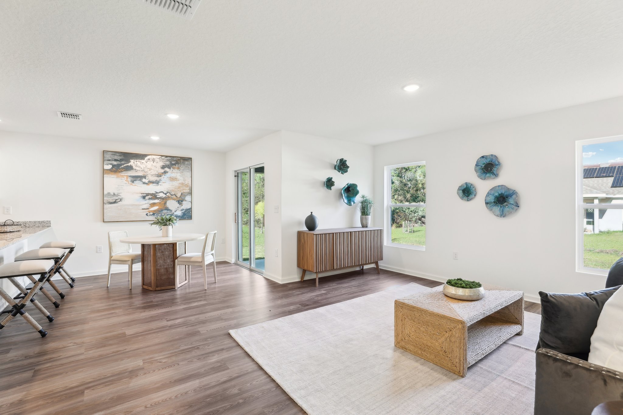 A large living room with a wood floor and a wood floor.