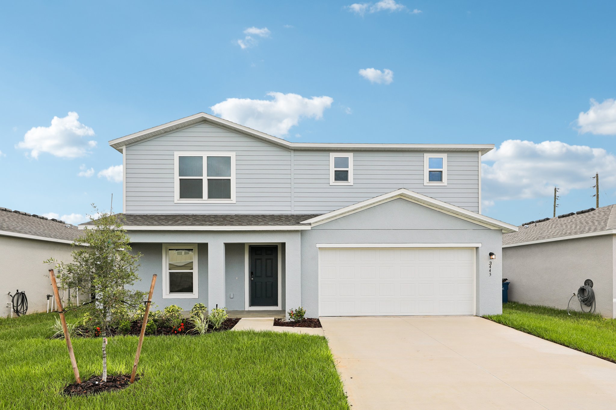 A white house with a driveway.