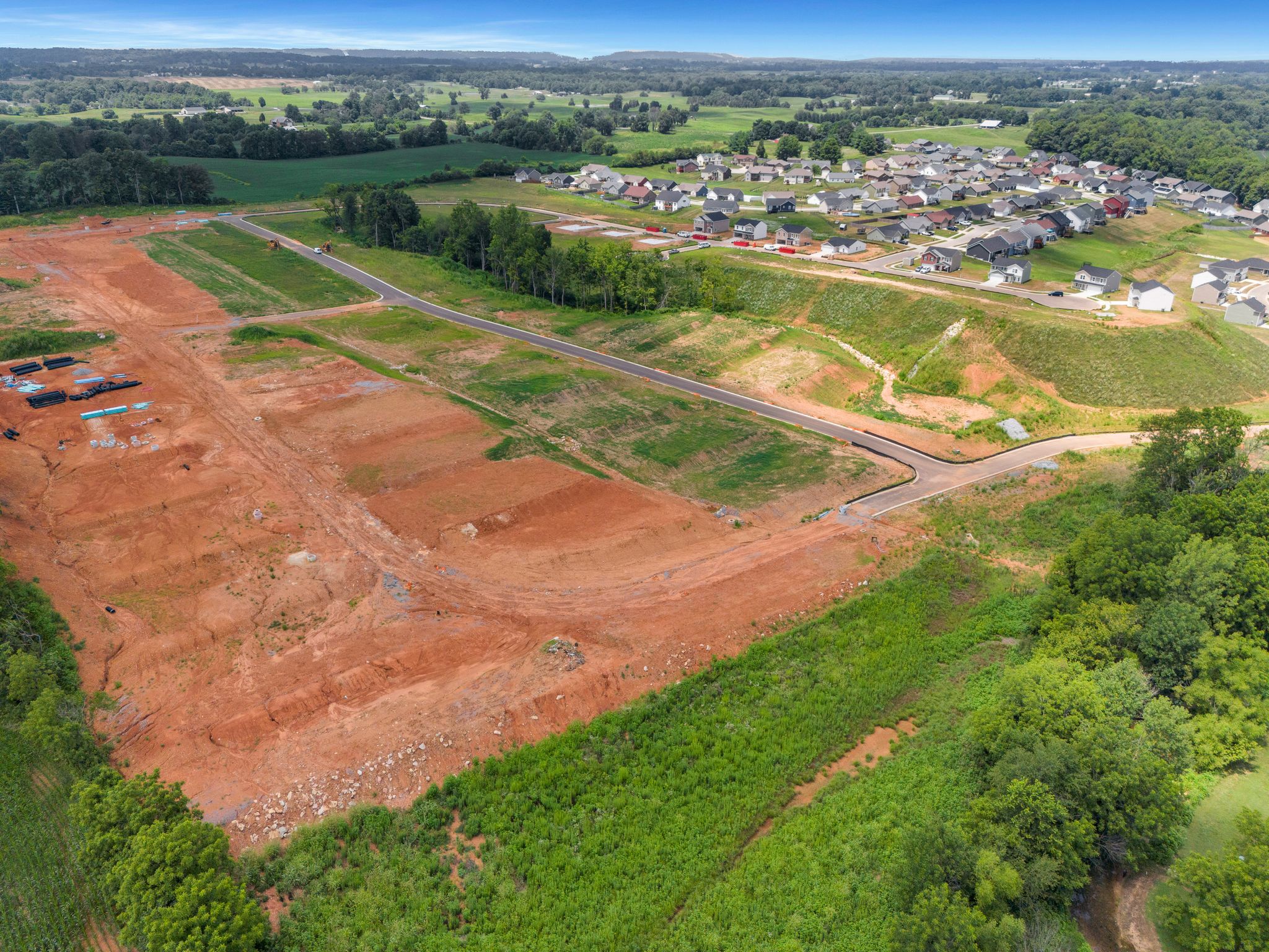 A landscape with a river and a town in the distance.