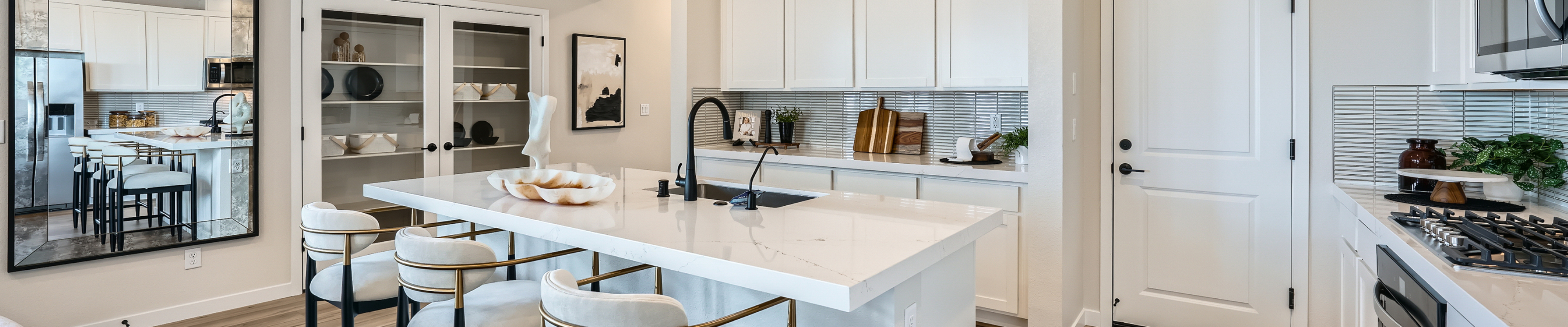 A kitchen with white cabinets.